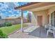 Relaxing covered patio overlooking the backyard and artificial grass lawn at 9837 W Tonopah Dr, Peoria, AZ 85382