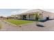 View of the backyard, highlighting the covered patio and artificial turf at 1228 N 106Th Pl, Mesa, AZ 85207