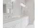 Bright bathroom featuring double sinks, white cabinetry and sleek countertops, with stylish mirrors at 1228 N 106Th Pl, Mesa, AZ 85207