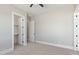 Bright bedroom with a ceiling fan, carpet, and convenient access to the walk-in closet at 1228 N 106Th Pl, Mesa, AZ 85207