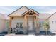Close up of an inviting home entrance with stylish wood supports and front porch at 1228 N 106Th Pl, Mesa, AZ 85207
