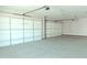 Spacious two car garage with two garage doors and ample lighting overhead at 1228 N 106Th Pl, Mesa, AZ 85207