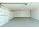 Bright and clean two car garage with ample natural light and white walls at 1228 N 106Th Pl, Mesa, AZ 85207