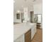 Bright kitchen with a large kitchen island featuring stainless steel appliances and ample lighting at 1228 N 106Th Pl, Mesa, AZ 85207