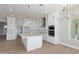 Modern kitchen featuring white cabinetry, a large island, and stainless steel appliances at 1228 N 106Th Pl, Mesa, AZ 85207