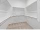 Spacious walk-in closet featuring multiple shelves and hanging rods for ample storage solutions at 1228 N 106Th Pl, Mesa, AZ 85207