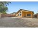 An exterior view of the home and back patio, along with gravel and walls at 12333 W Marshall Ave, Litchfield Park, AZ 85340