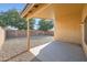 View of covered back patio and gravel filled backyard with block wall at 12333 W Marshall Ave, Litchfield Park, AZ 85340