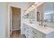 Bright bathroom with double sinks, white cabinetry, and a separate shower, exuding a modern appeal at 12333 W Marshall Ave, Litchfield Park, AZ 85340