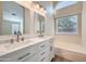 Elegant bathroom featuring double sinks, white marble countertops, and a luxurious soaking tub at 12333 W Marshall Ave, Litchfield Park, AZ 85340