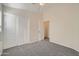 Neutral bedroom with a ceiling fan, carpeted floor and a double door closet at 12333 W Marshall Ave, Litchfield Park, AZ 85340
