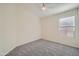 Cozy bedroom featuring plush gray carpeting and a large window offering plenty of light at 12333 W Marshall Ave, Litchfield Park, AZ 85340