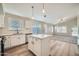 Modern kitchen featuring an island, stainless steel appliances, and seamless flow to the living area at 12333 W Marshall Ave, Litchfield Park, AZ 85340