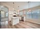 Modern kitchen featuring a center island, white cabinets, and stainless steel appliances, perfect for culinary adventures at 12333 W Marshall Ave, Litchfield Park, AZ 85340