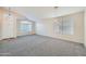 Bright and spacious living room with plush carpeting, lots of natural light, and a neutral color palette at 12333 W Marshall Ave, Litchfield Park, AZ 85340