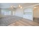 Open-concept living room featuring plush carpeting, lots of natural light, and seamless kitchen access at 12333 W Marshall Ave, Litchfield Park, AZ 85340