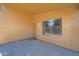 A covered patio area featuring a security door, textured walls, and concrete floor at 12333 W Marshall Ave, Litchfield Park, AZ 85340