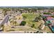 Aerial view showcases the community park with playground, volleyball court, ramadas, and paved walkways at 13196 W Coronado Rd, Goodyear, AZ 85395