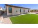 Well maintained backyard showing a vibrant green lawn with a view of the home's exterior at 13196 W Coronado Rd, Goodyear, AZ 85395