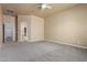 Spacious bedroom featuring neutral carpet, paint, and a ceiling fan, ready for personalization and comfort at 13196 W Coronado Rd, Goodyear, AZ 85395