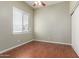 Bedroom featuring wood flooring, a window with blinds, and a sliding door closet, perfect for a guest room at 13196 W Coronado Rd, Goodyear, AZ 85395