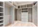 Custom walk-in closet with shelving, drawers, and wood flooring for optimal storage and organization at 13196 W Coronado Rd, Goodyear, AZ 85395