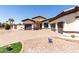 Front exterior with three car garage, desert landscaping with green grass at 13196 W Coronado Rd, Goodyear, AZ 85395