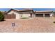 Exterior of home with three car garage and desert landscaping at 13196 W Coronado Rd, Goodyear, AZ 85395