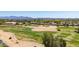 Aerial view of the community golf course, showcasing the lush green fairways, sand traps, and the surrounding neighborhood at 13196 W Coronado Rd, Goodyear, AZ 85395