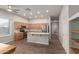Well-lit kitchen featuring an island, stainless steel appliances, and tile flooring at 13196 W Coronado Rd, Goodyear, AZ 85395