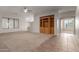 Living room featuring carpeting, ceiling fan, and a built in entertainment center at 13196 W Coronado Rd, Goodyear, AZ 85395