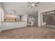 Open-concept living space with tile flooring, neutral walls, and kitchen view at 13196 W Coronado Rd, Goodyear, AZ 85395