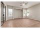 Living room with tile flooring, multiple windows, and sliding glass door at 13196 W Coronado Rd, Goodyear, AZ 85395