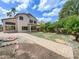 Spacious backyard with manicured lawn, mature trees, brick paver patio and a dedicated firepit area at 1360 E Washington Ave, Gilbert, AZ 85234