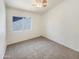 Clean and bright bedroom with plush carpeting and a window offering natural light at 1360 E Washington Ave, Gilbert, AZ 85234