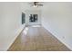 Light-filled bedroom with tile flooring, ceiling fan and a serene atmosphere at 1360 E Washington Ave, Gilbert, AZ 85234