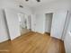 Bright bedroom featuring hardwood floors, closet, with adjacent rooms for versatile living at 1360 E Washington Ave, Gilbert, AZ 85234