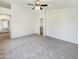 Carpeted bedroom offering ceiling fan, bright walls and easy access to a bathroom at 1360 E Washington Ave, Gilbert, AZ 85234