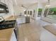 Bright kitchen with stainless steel appliances, stone countertops, and tile floors at 1360 E Washington Ave, Gilbert, AZ 85234