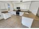 Well-lit kitchen featuring white cabinets, granite countertops, and modern stainless steel appliances at 1360 E Washington Ave, Gilbert, AZ 85234