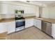 Modern kitchen featuring stainless steel appliances, white cabinets, and stone countertops at 1360 E Washington Ave, Gilbert, AZ 85234