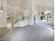 Bright living room with vaulted ceilings, decorative hanging lights, an open staircase, and plush carpet at 1360 E Washington Ave, Gilbert, AZ 85234