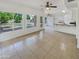 Large living room with tile floors, natural light, and access to the kitchen and backyard at 1360 E Washington Ave, Gilbert, AZ 85234