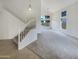 Open living room showcasing a staircase, vaulted ceilings, carpet, and large windows offering backyard views at 1360 E Washington Ave, Gilbert, AZ 85234