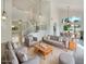 Bright living room with vaulted ceilings, decorative hanging lights, an open staircase, and dining area at 1360 E Washington Ave, Gilbert, AZ 85234