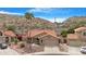 Aerial view of a home featuring desert landscaping, tile roof, mountain views, and a two-car garage at 15437 S 23Rd Pl, Phoenix, AZ 85048