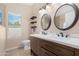 Modern bathroom with double sinks, wood cabinets, and stylish fixtures at 15437 S 23Rd Pl, Phoenix, AZ 85048