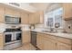 Kitchen view showcasing stainless steel appliances and bright cabinets at 15437 S 23Rd Pl, Phoenix, AZ 85048