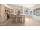 Open kitchen featuring an island, stainless steel appliances, and neutral tile floors at 15437 S 23Rd Pl, Phoenix, AZ 85048