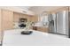 Modern kitchen with stainless steel appliances, light wood cabinets, and a quartz countertop island at 15437 S 23Rd Pl, Phoenix, AZ 85048